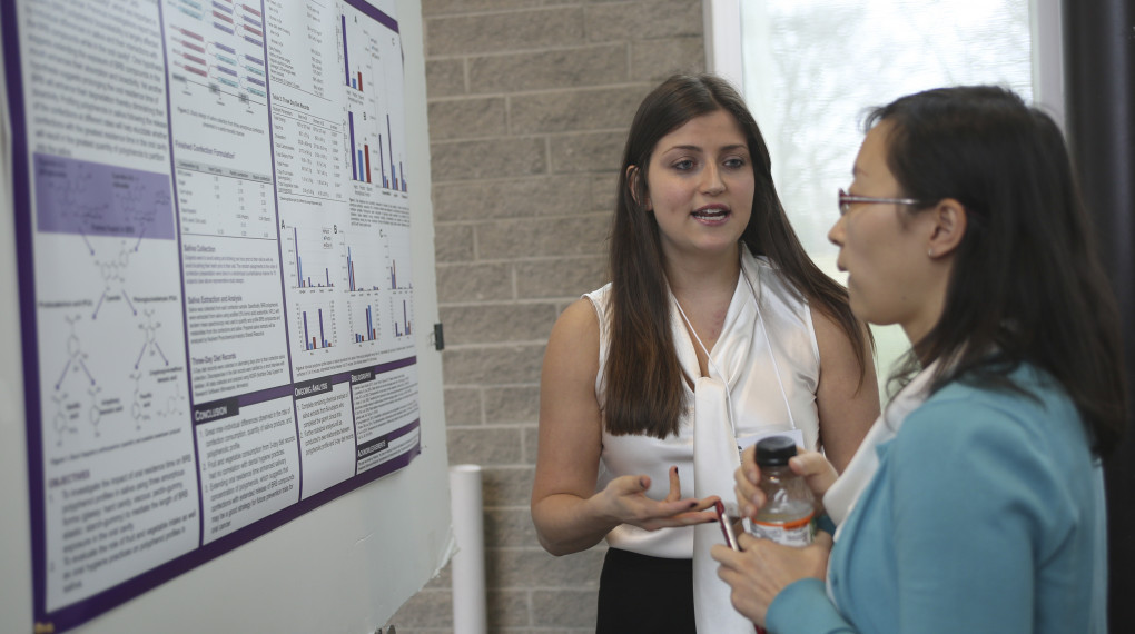 Grad students at research poster