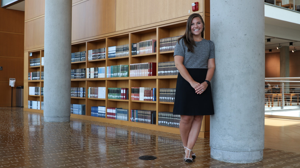 business student standing in library