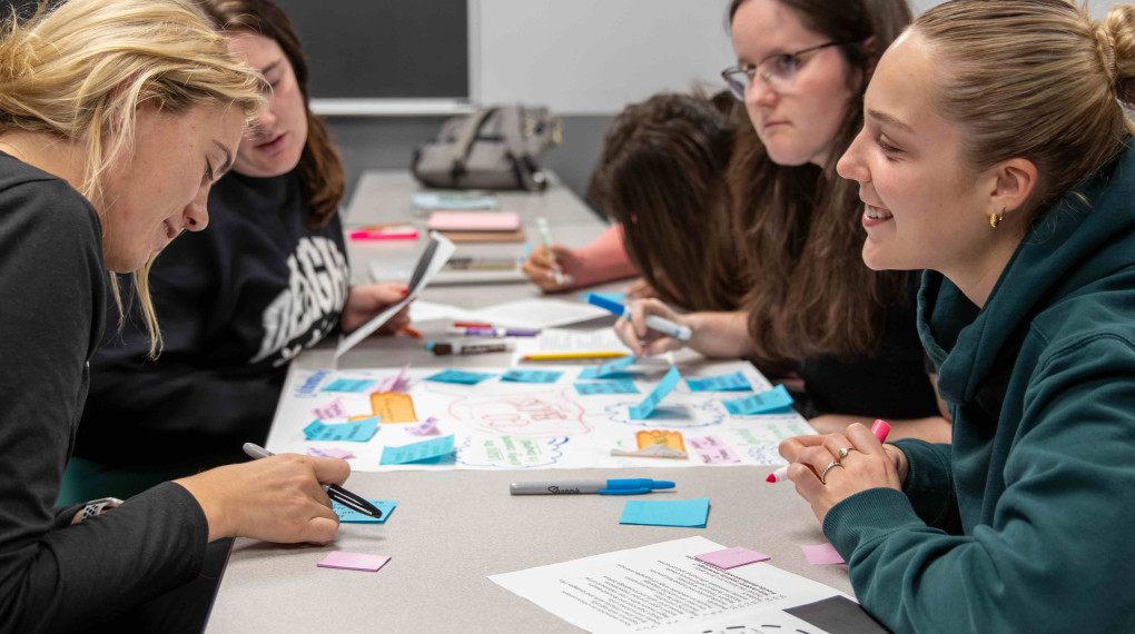 Classroom of Ohio State students working at a table together.