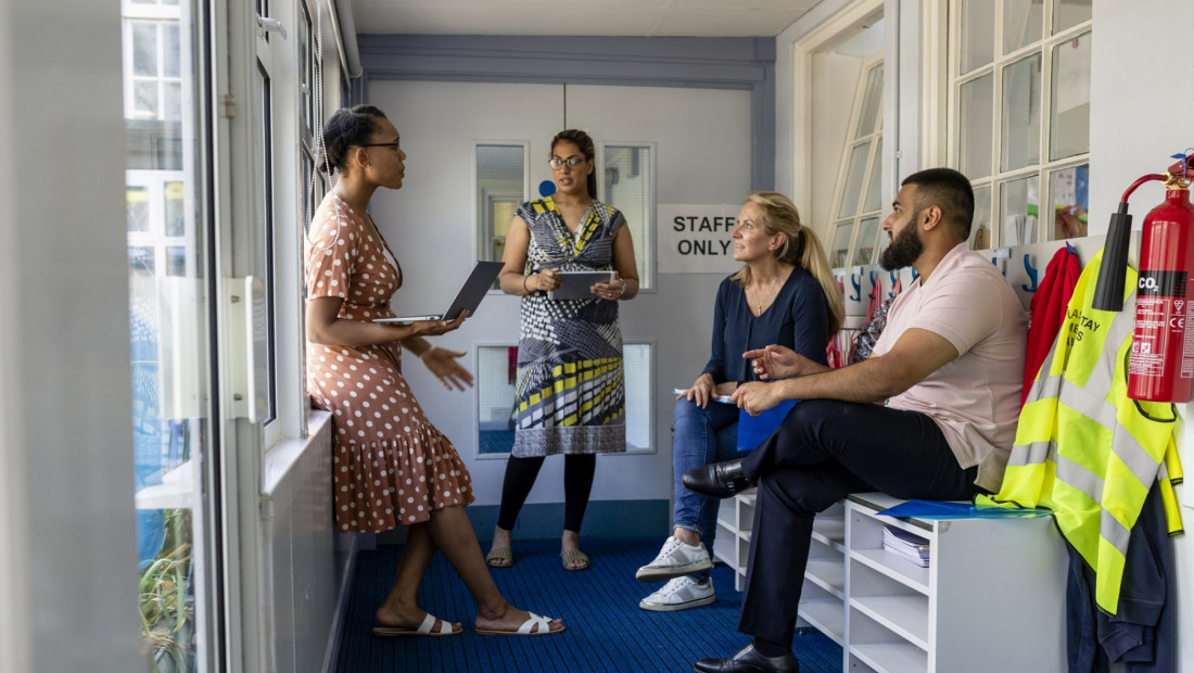 group of teachers meeting in classroom