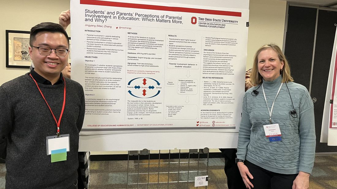 Research presenters posing with their poster at forum