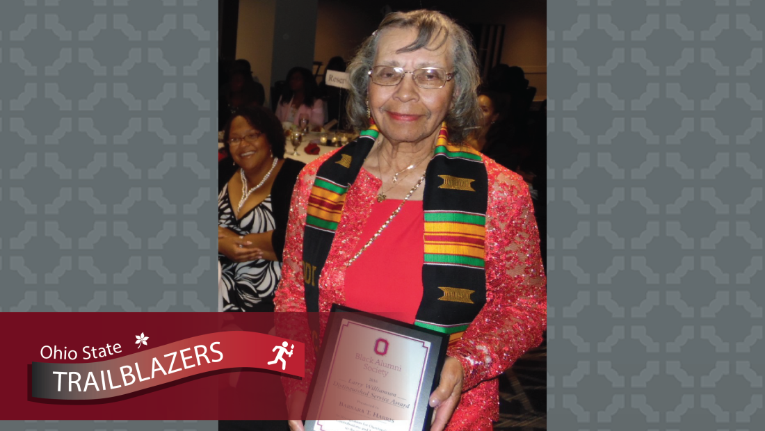 Barbara Harris holding an award from Ohio State