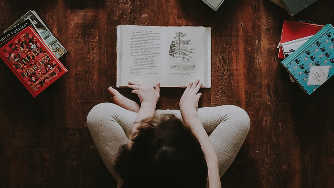 child sitting over book