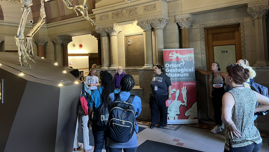 Ohio State STEAMM Rising program at a museum looking at dinosaur skeleton