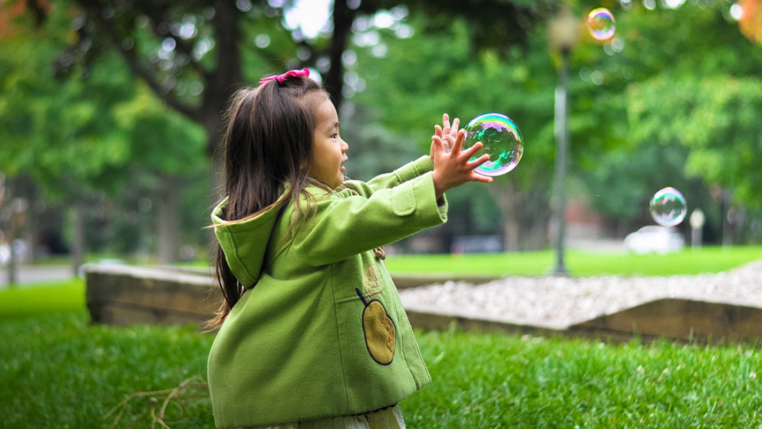 Girl chasing bubble