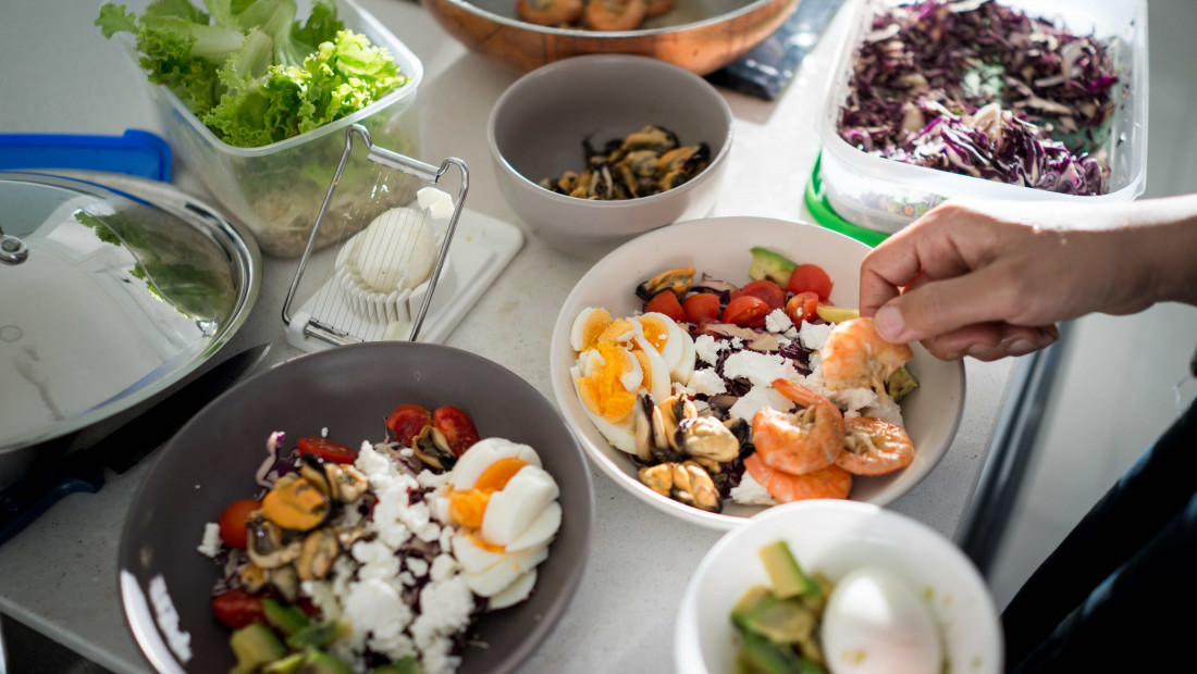 ingredients for healthy meals being prepped in containers