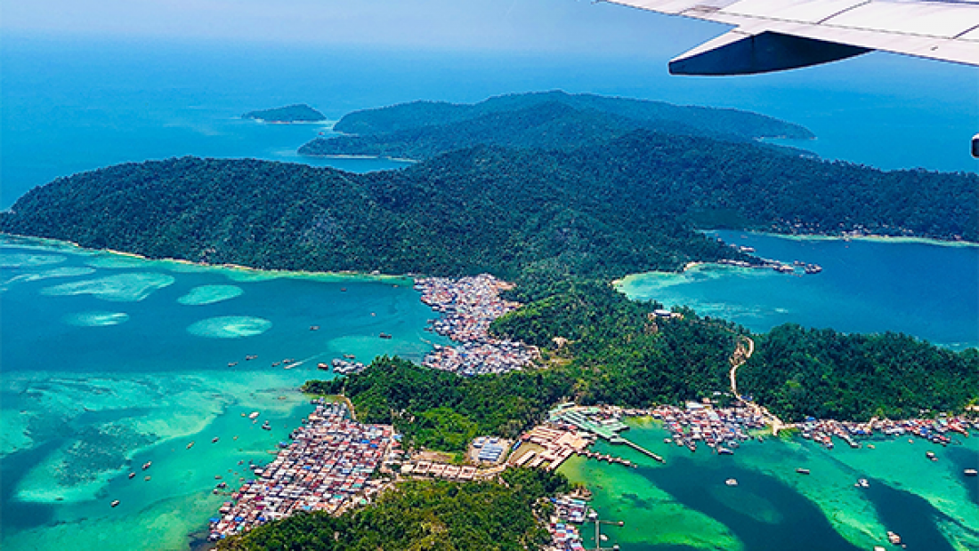 Overhead shot of tropical island from an airplane window