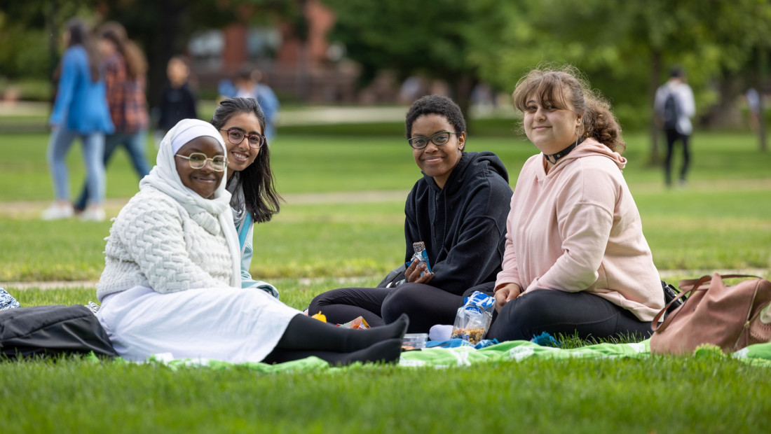 Ohio State students sitting on the grass