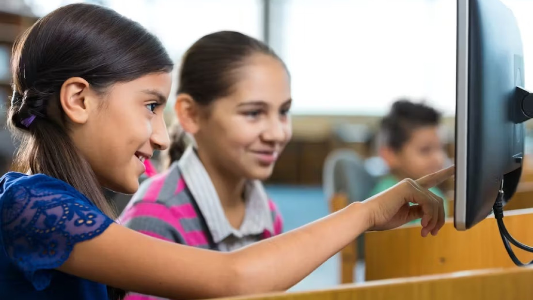 Young students working at a library computer