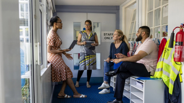 group of teachers meeting in classroom
