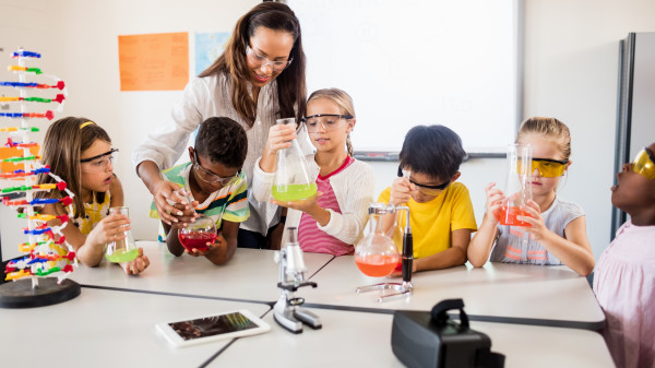 Science teacher helping students