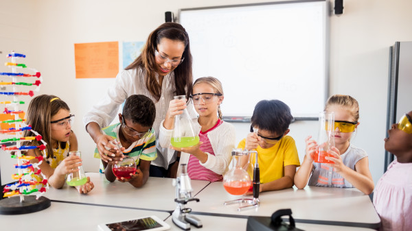 Science teacher helping students