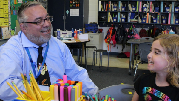 Adult and child in classroom