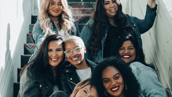 Group of diverse female students sitting on stairs