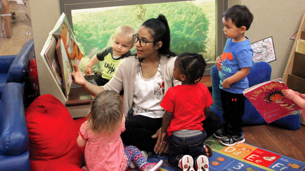 teacher reading book to children