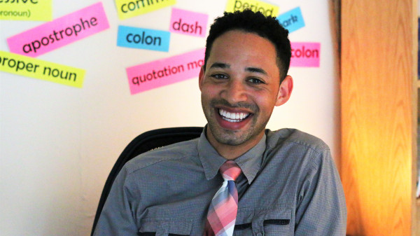 young teacher sitting in his classroom