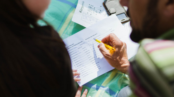 person pointing on paper