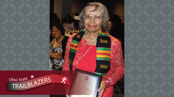 Barbara Harris holding an award from Ohio State
