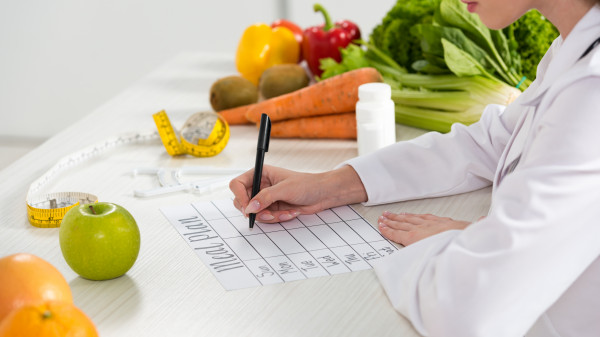 dietitian writing in meal plan