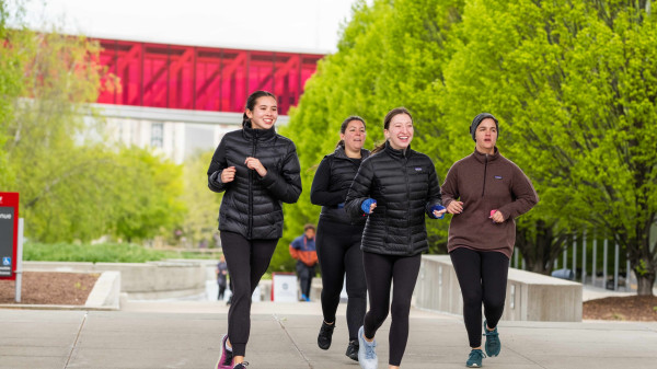 Group of Ohio State students jogging through campus