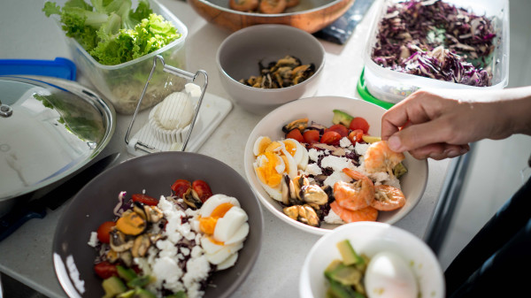 ingredients for healthy meals being prepped in containers