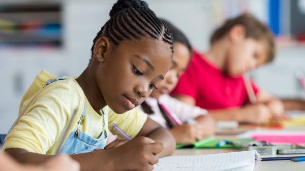 school girl writing in class