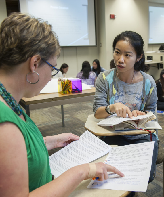 World language teacher helping students in class