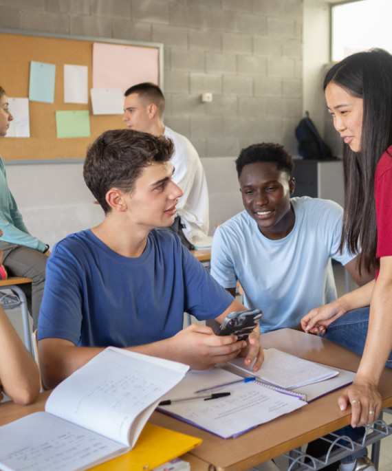 High school students conversing in a classroom