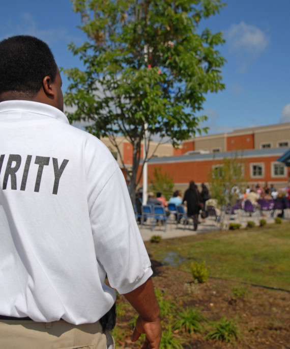 Security guard out front of a school building