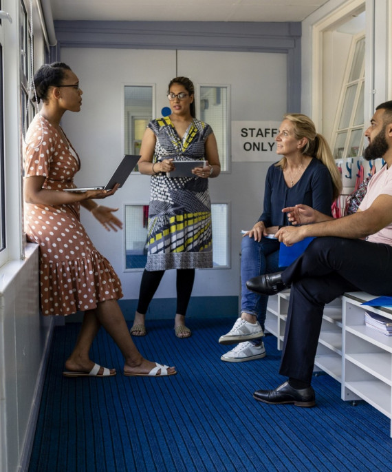 group of teachers meeting in classroom