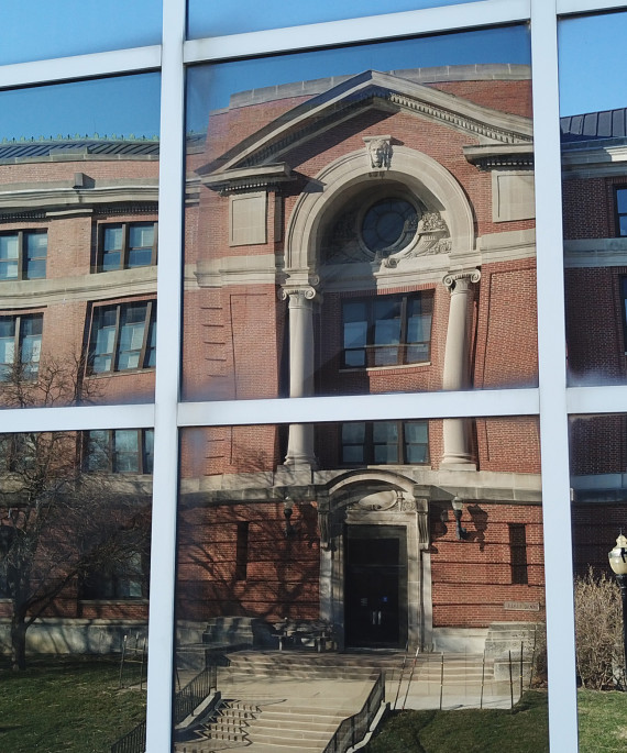 reflection of Arps hall in a pane window