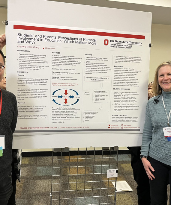 Research presenters posing with their poster at forum