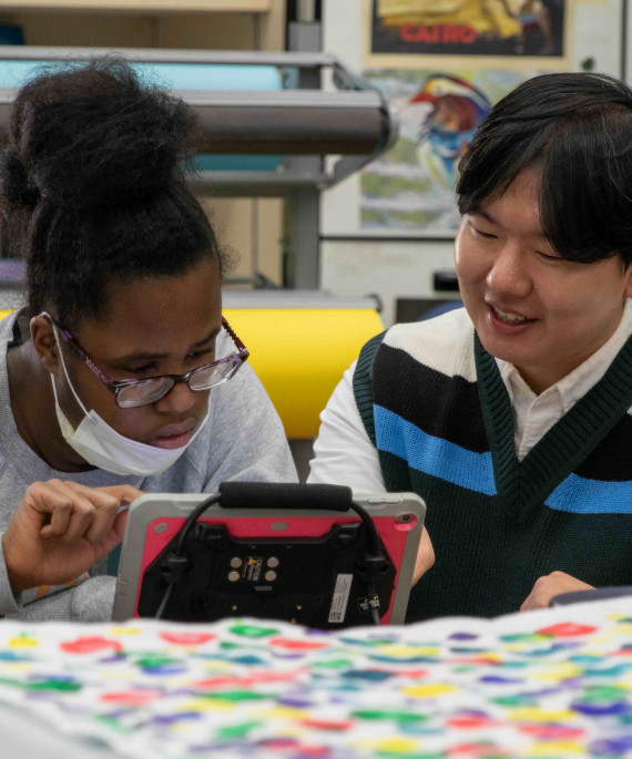 Behavior analysts working with a student in a classroom