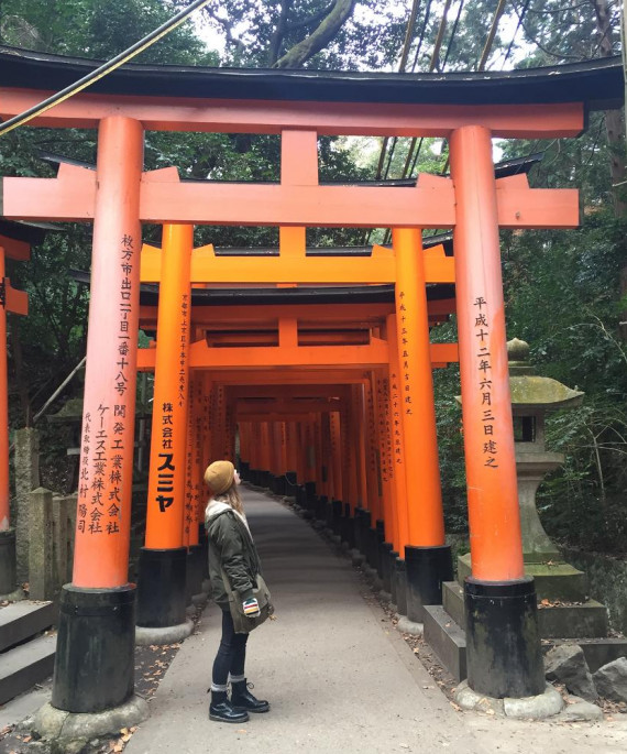 student standing be tori gate in Japan