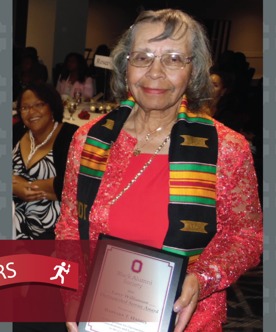 Barbara Harris holding an award from Ohio State