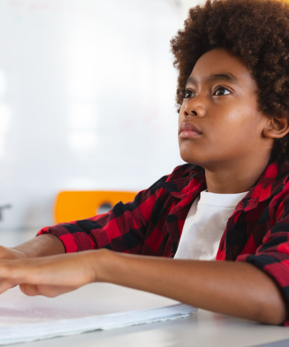 blind schoolboy sitting at desk