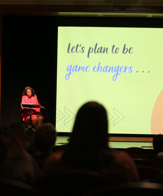 Presenter on stage giving a lecture