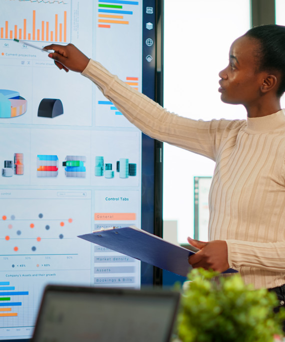 a woman giving a presentation to a group of people