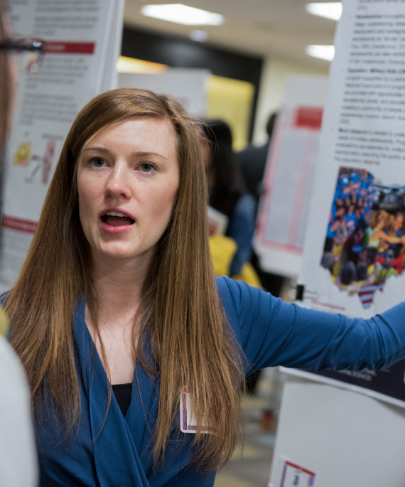 student with research poster