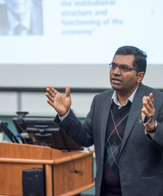 a man standing in front of a podium giving a presentation