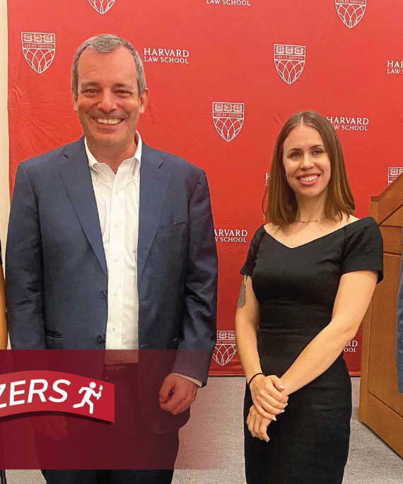 Kelly Capatosto and Harvard collegues with Ohio State Trailblazers logo