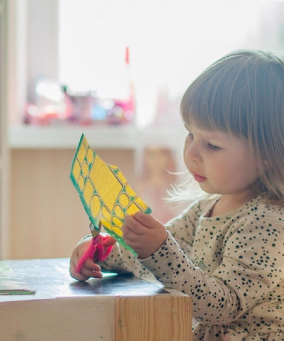 kindergarten student doing arts and crafts