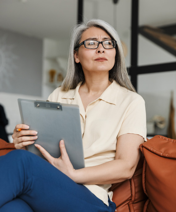 mature-business-woman-holding-clipboard