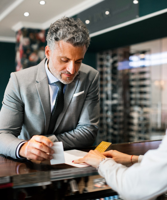 mature-businessman-at-hotel-reception