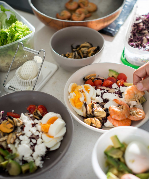 ingredients for healthy meals being prepped in containers