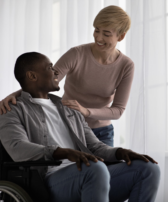 caregiver talking to person in wheelchair