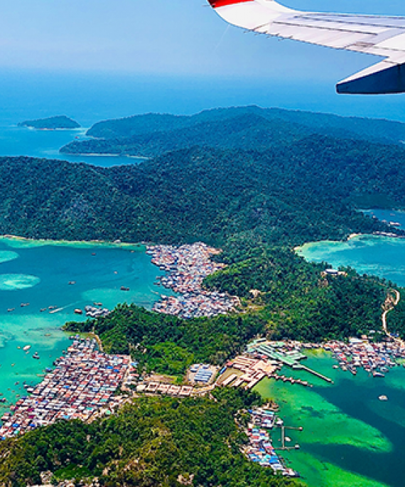 Overhead shot of tropical island from an airplane window