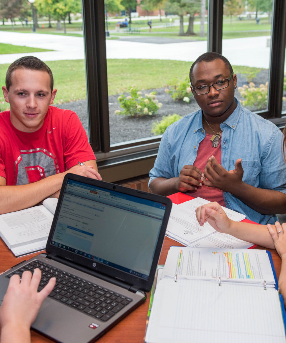 students doing homework around table