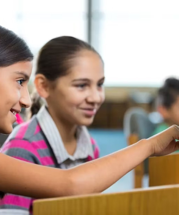 Young students working at a library computer