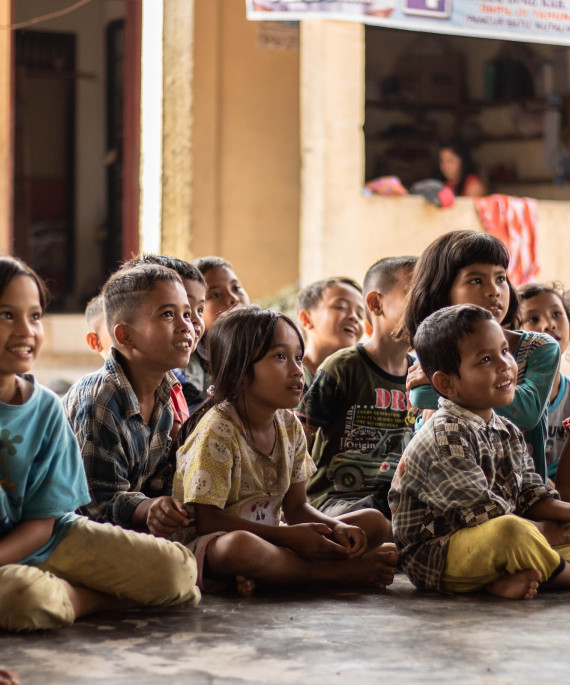 students seated outside a school